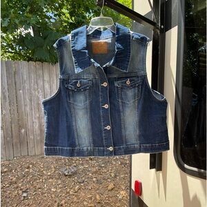 Adorable denim vest with lace embellishment on the back.